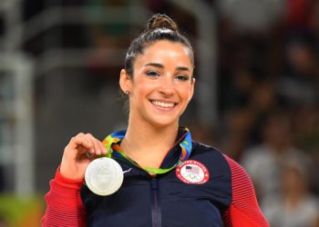 Gymnast Aly Raisman Champions Self-Care In A Bathrobe By The Fire